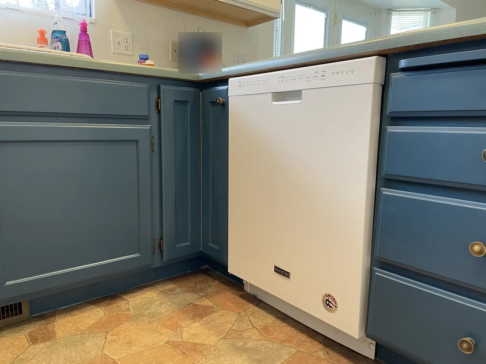 Lower kitchen cabinets and drawers painted a muted blue
